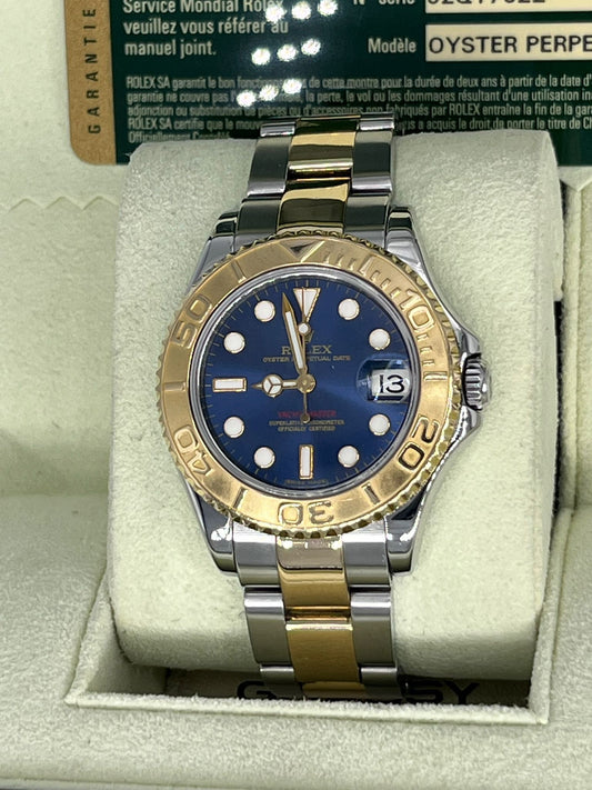 Reloj de oro y acero, Marca: ROLEX, Modelo: YACHTMASTER, Refereencia: 168623, 35mm, con caja y papeles.